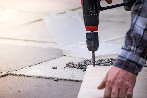 Drilling and fitting work on a paved area