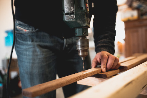 Drilling pilot holes into timber in the workshop